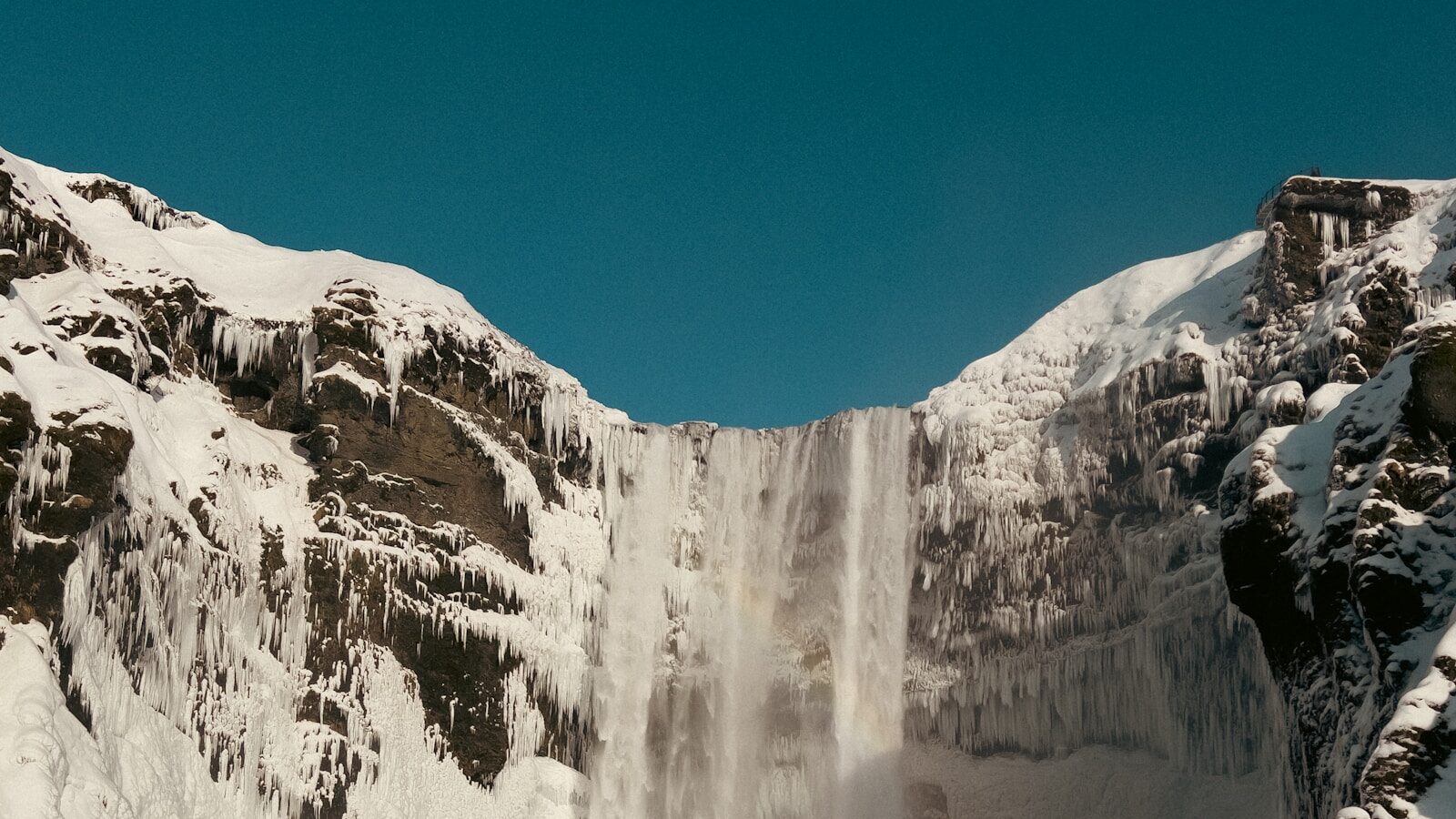 a waterfall in a snowy place